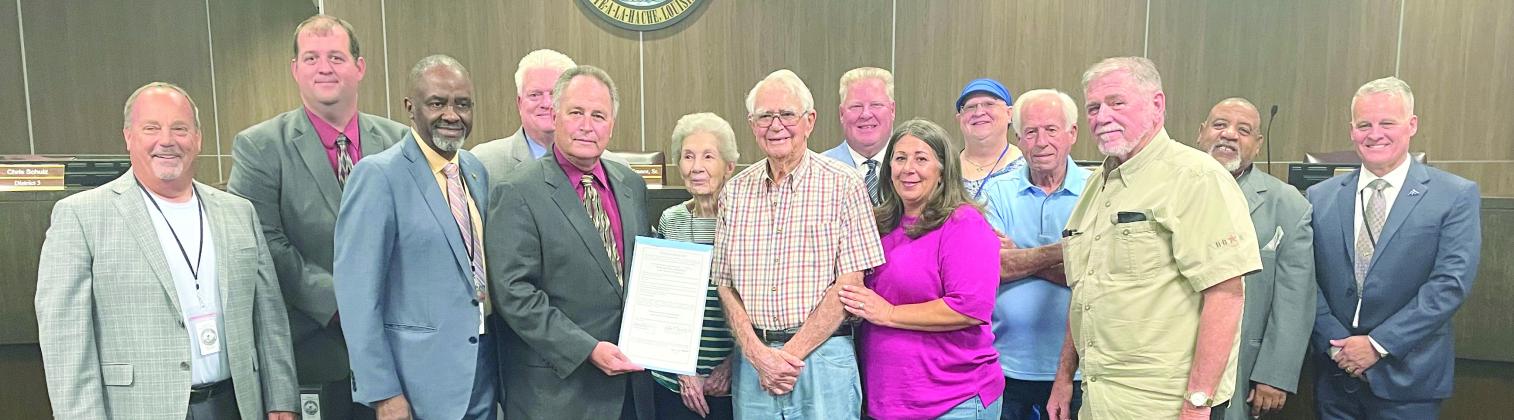 Doris and Paul LeBoeuf accept their proclamation from parish president Keith Hinkley and parish council members.