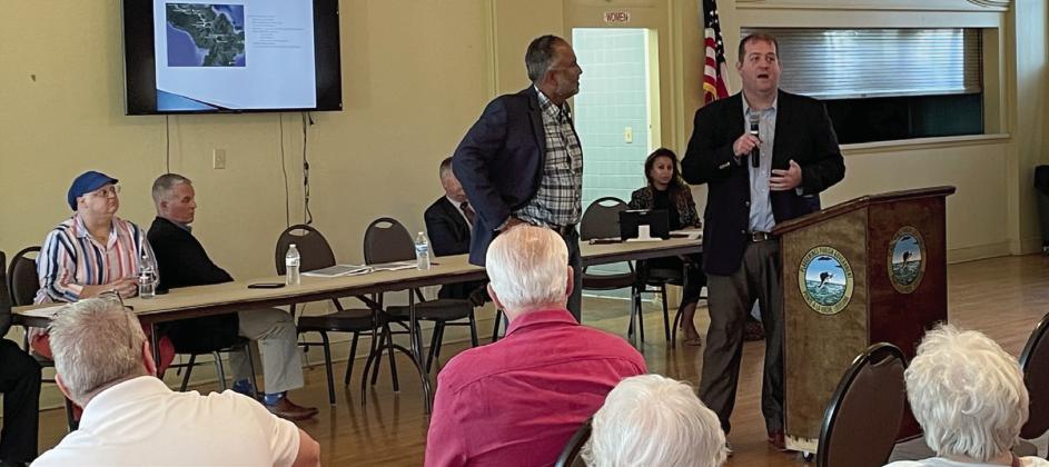 Port executive director Charles Tillotson (left) and district 3 council member Chris Schulz (right) speak to crowd of residents at public town hall meeting.