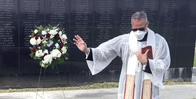 Father Kyle gives a prayer during the wreath laying ceremony the Medal of Honor Park on May 24 to honor fallen soldiers in observance of Memorial Day.