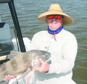Cousin Rob Sporl with a black drum caught in the early morning.