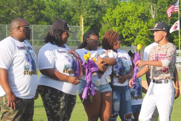 Belle Chasse High School (BCHS) Men’s Baseball Team members and their parents held a ceremony in memory of their former teammate, Keyron “Tootie” Ross, and to honor his mother, Makita Wells-Hartford, at the district playoff game held on Thursday, April 21. Photo by Amber Prattini Wallo