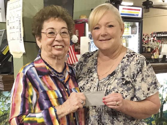 Carol Cooper (left), the owner of Zydeco's Restaurant in Belle Chasse, presents Sandra Bertucci of Marrero (right) with a $100 restaurant gift card, which was raffled on Mother's Day, Sunday, May 14. There will be another $100 gift card raffle held on Father's Day, Sunday, June 18.