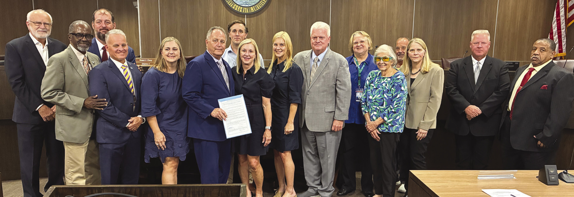 Parish President Keith Hinkley and parish council members present the Cossich family with a proclamation honoring the life and legacy of Philip Cossich Jr., a prominent parish lawyer and a respected community member.