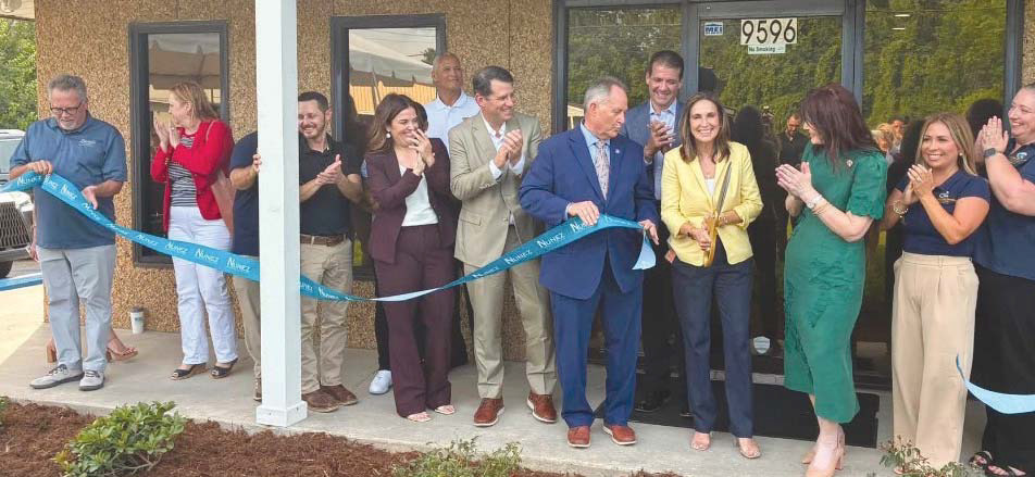 Local government o cials, school board o cials, representatives from parish businesses, and Nunez o cials celebrate the new facility with a ribbon cutting.
