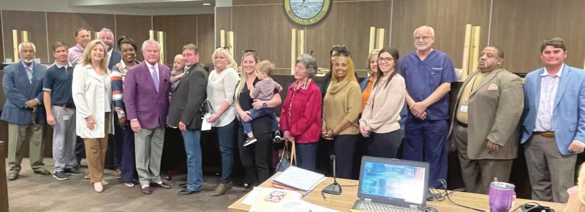 Donald Durr poses with port administration, commissioners, and family members as they thank him for his 35 years of service. Photo by Justin Walton