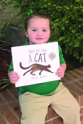 Belle Chasse Primary Pre-K student Myla Smith, daughter of Brandi Rollo and David Smith, poses with her book from the Oct. 26 session.