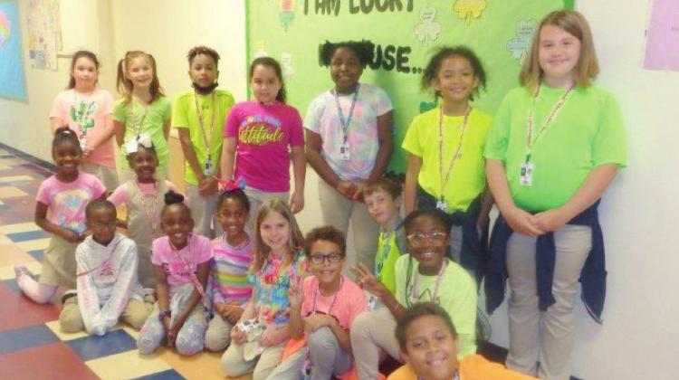 Third grade during Read Across America Week – Reading Makes You Glow Day! Pictured are: Karaline Landrum, Neveah Newman, Jaire Larrieu, Victoria Rivera, Amari Morrison, Shaylah Kelly, Addison Cazel, Kennedy Hodges, Zoe Wilright, Josiah Zeak, Symphony Jones, Leander Taylor, J'honae Turner, Leyann Sibley, Caden Novonty, Christopher Mesfen-Pierce and Jack Reeves.  Derrick Wilson II and Mrs. Rivera during Read Across America Week – Reading is our Superpower Day!