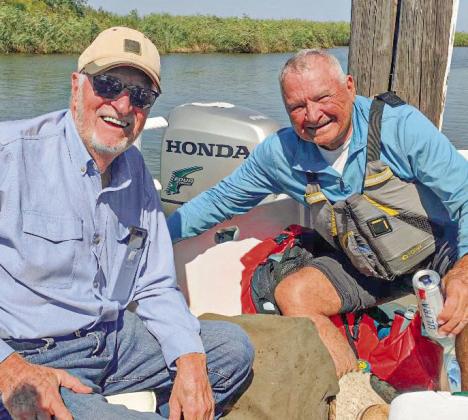 Leland Walker celebrates his journey down the Mississippi River with Darryl Bubrig Sr.
