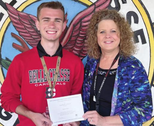 Pictured with National Merit Finalist Ryan Miller is Jemi Carlone, Principal of Belle Chasse High School.