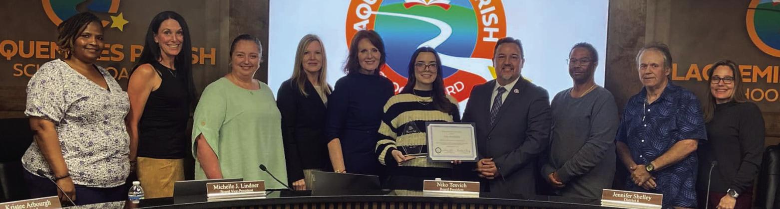 Board members present Belle Chasse High School Senior Amy Hochhalter with her Student of the Year Award.