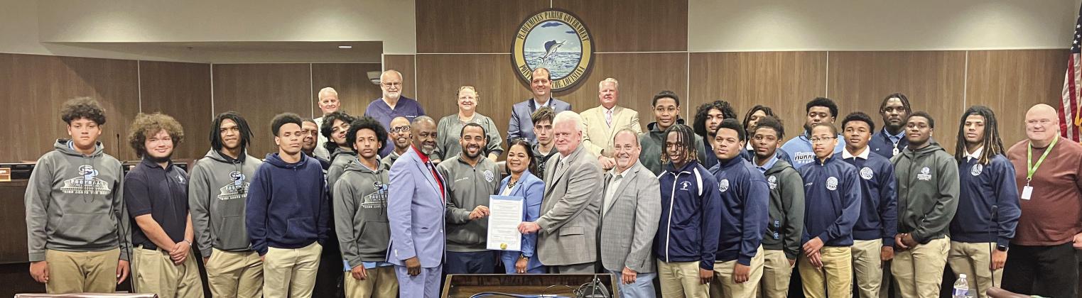 Council members pose for a photo with South Plaquemines football coach Lyle Fitte and players after approving proclamation declaring January 9 as “South Plaquemines High Day” to honor their state championship victory.