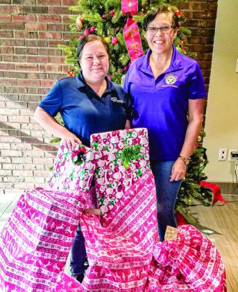Kim Encalade receives gifts for her family. Pictured, from left: Kim Encalade and Rae Riley, VictimAssistance Coordinator and Project L.E.A.D. Coordinator.