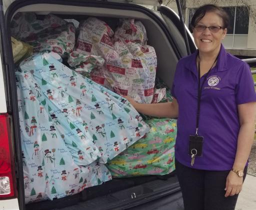 Rae Riley with a van full of gifts to deliver. There were two loads of gifts delivered.