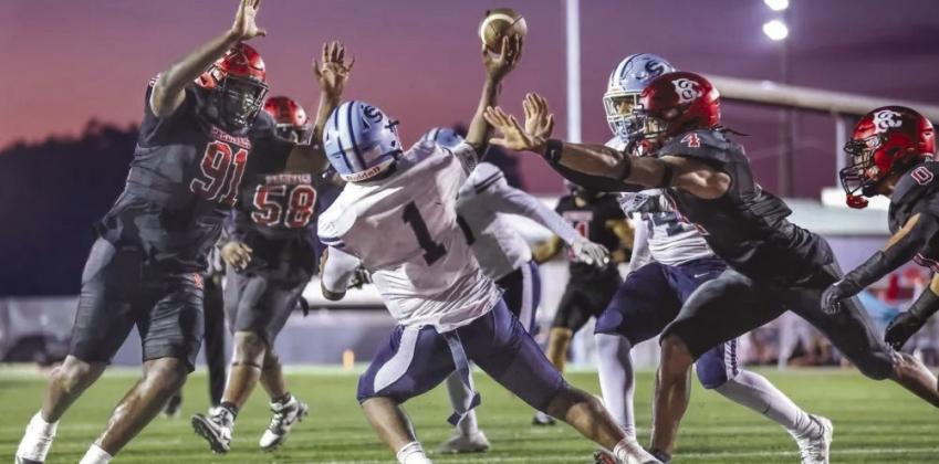 BCHS seniors Savion Barthelemy, #91, and Logan Jackson, #4, are closing in on SPHS' quarterback in the “Battle of the Boot” matchup earlier this season. Barthelemy has signed with Washington State University and Jackson with Nicholls State University for the Fall.