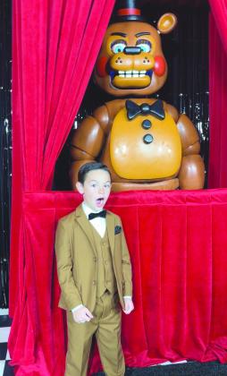 Logan is joined at the Hollywood premiere with Freddy Fazbear, an animatronic from the film.