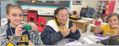 Belle Chasse Academy sixth graders Alexis Timms, Hartley Fernino and Josie McBride compare volume to surface area in their geometry unit.