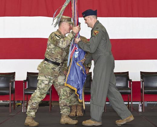 Maj. Gen. Thomas Friloux, the adjutant general of Louisiana, passes the unit guidon to Col. Christopher 'Cli' Ridlon during the 159th Fighter Wing change of command ceremony at Naval Air Station Joint Reserve Base New Orleans, July 11, 2026. The passing of the guidon symbolizes the formal transfer of command. Photo by Technical Sgt. Cindy Au-Wiafe