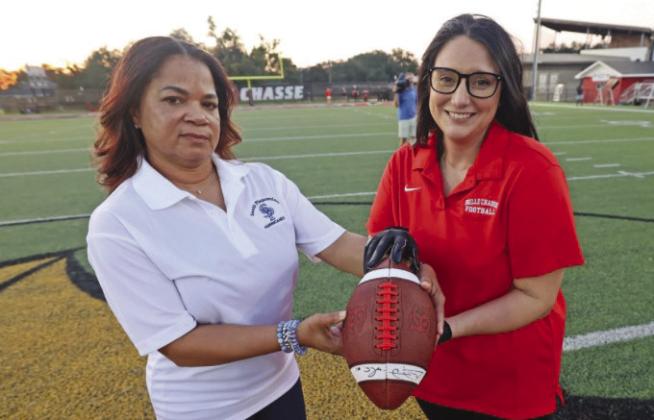 Principals Trichina Wiliams (SPHS) and Heather Lawson (BCHS) holding honorary football before the Battle of the Boot.