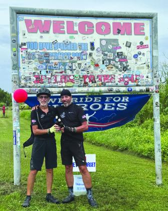 (From left) McCourt and Lipuma celebrating the completion of their 2,500-mile bike ride down the Mississippi River.