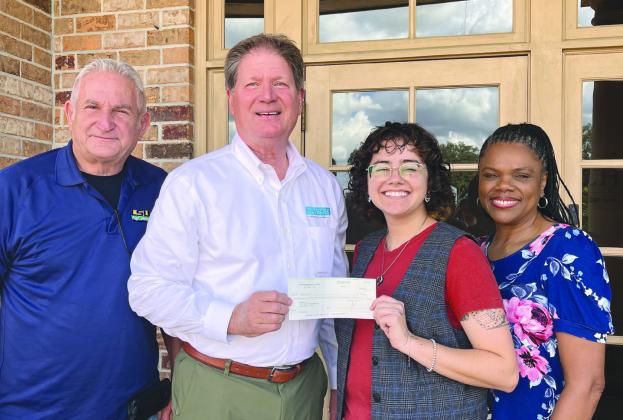 4-H sta Wayne Burgess, Lou Duplantier, and Marlena Cowart receive a donation from George Pivach II of the Venice Port Complex.