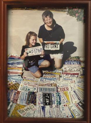 Abbey and Grandmother Glenda with some of license plates donated.