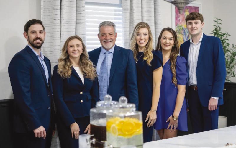 The Nielsen Investments team enjoy their new conference room. From Left: Cameron Coldren, Taylor Buras, David Nielsen, Blaine Nielsen-Braddock, Ashton Galt &amp;amp; Brennan Molin.