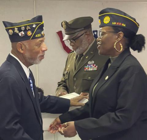 Outgoing commander Joseph Williams congratulates First Vice Commander Dr. Toshiba Narcisse on her new role.