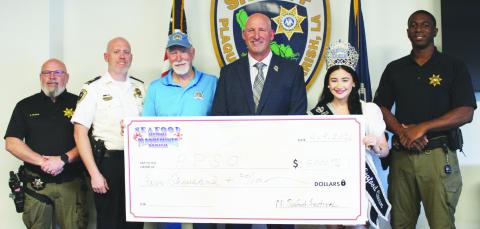 From left: Sgt. Anthony Dugas, Captain Chris Johnson, Ernie Kientz, Sheri Jerry Turlich, Seafood Festival Queen Kadence Johnson, Detective Tre Sanders.