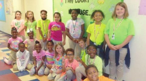 Third grade during Read Across America Week – Reading Makes You Glow Day! Pictured are: Karaline Landrum, Neveah Newman, Jaire Larrieu, Victoria Rivera, Amari Morrison, Shaylah Kelly, Addison Cazel, Kennedy Hodges, Zoe Wilright, Josiah Zeak, Symphony Jones, Leander Taylor, J'honae Turner, Leyann Sibley, Caden Novonty, Christopher Mesfen-Pierce and Jack Reeves.  Derrick Wilson II and Mrs. Rivera during Read Across America Week – Reading is our Superpower Day!