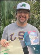 Nikolas Reznik holding his winnings for the 5th Annual Hike-a-Thon.