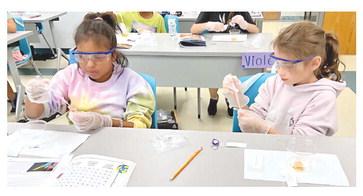 The STEAM Department at Nunez Community College will o er more than 10 multi-day camps for young students this summer. Pictured, students conduct an experiment in a past Astro Camp at Nunez.