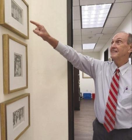 Louisiana Supereme Court Chief Justice John Weimer points to the photograph of his wife and three daughters in his chambers. He described them as 'his best work'.