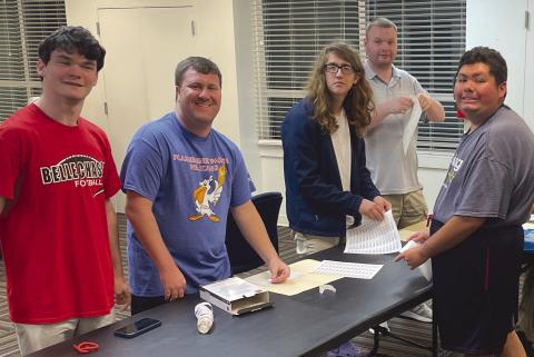 Plaquemines Pelicans hard at work putting labels on envelopes for annual donation drive.