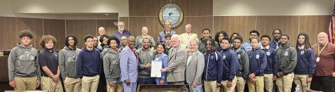 Council members pose for a photo with South Plaquemines football coach Lyle Fitte and players after approving proclamation declaring January 9 as “South Plaquemines High Day” to honor their state championship victory.
