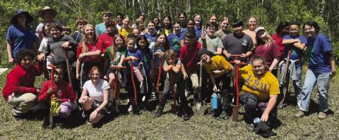 Belle Chasse Middle School students pose for a group photo after planting 363 native trees in Port Sulphur - the rewarding culmination of their . rst year participating in the LSU Coastal Roots Program.