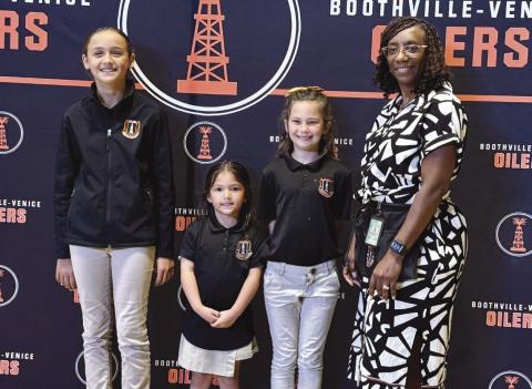 From left: Harper Guidry, Naveah Hua, Gracie Busby, and Principal Maria Prout.