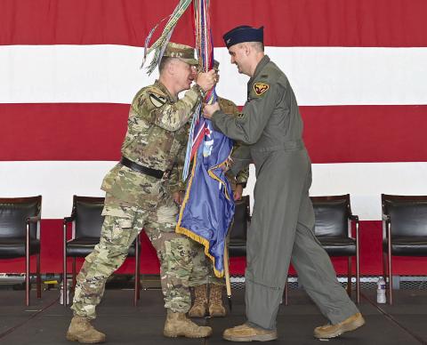 Maj. Gen. Thomas Friloux, the adjutant general of Louisiana, passes the unit guidon to Col. Christopher 'Cli' Ridlon during the 159th Fighter Wing change of command ceremony at Naval Air Station Joint Reserve Base New Orleans, July 11, 2026. The passing of the guidon symbolizes the formal transfer of command. Photo by Technical Sgt. Cindy Au-Wiafe