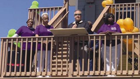 Parish president Keith Hinkley speaks during celebration of the reconstruction of . ve Ironton homes with members of the Ironton Reconstruction and Development Committee (IRAD) standing by his side.