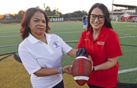 Principals Trichina Wiliams (SPHS) and Heather Lawson (BCHS) holding honorary football before the Battle of the Boot.