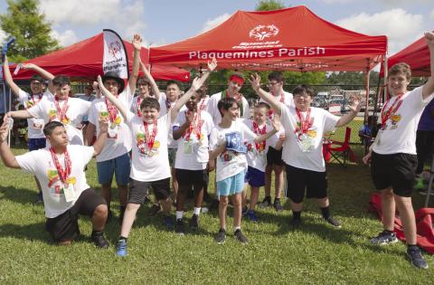 Athletes posing with their medals from the Track and Field competition at the State Summer Games.