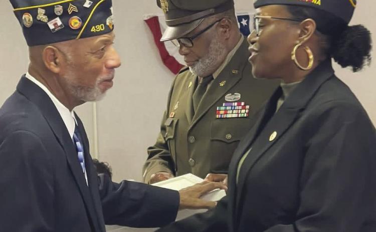 Outgoing commander Joseph Williams congratulates First Vice Commander Dr. Toshiba Narcisse on her new role.