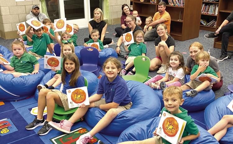 Belle Chasse Primary’s Pre-K students and their families gather in the school’s library for story-time at the November 2 Prime-Time Reading session.