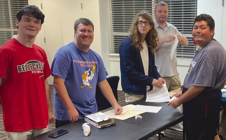 Plaquemines Pelicans hard at work putting labels on envelopes for annual donation drive.