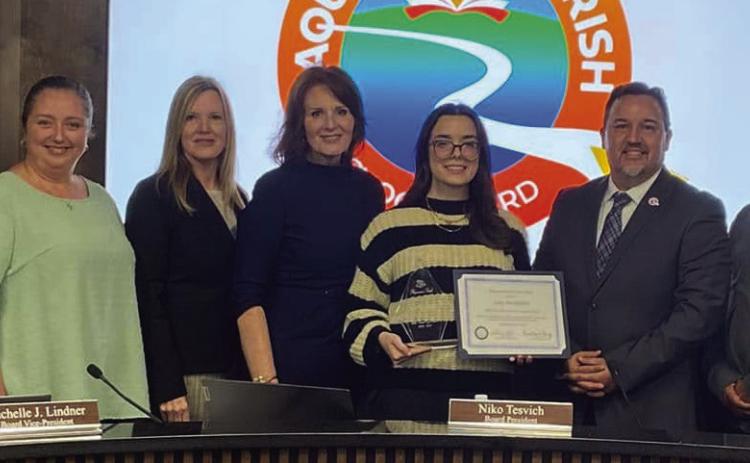 Board members present Belle Chasse High School Senior Amy Hochhalter with her Student of the Year Award.