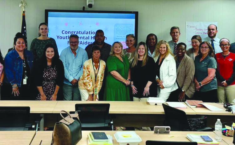 Teachers and other Belle Chasse High School sta participate in a mental health training session organized by the Magnolia Blossoms of Plaquemines.