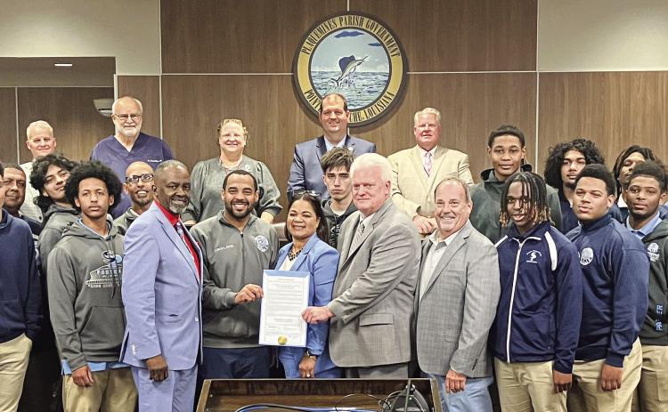 Council members pose for a photo with South Plaquemines football coach Lyle Fitte and players after approving proclamation declaring January 9 as “South Plaquemines High Day” to honor their state championship victory.