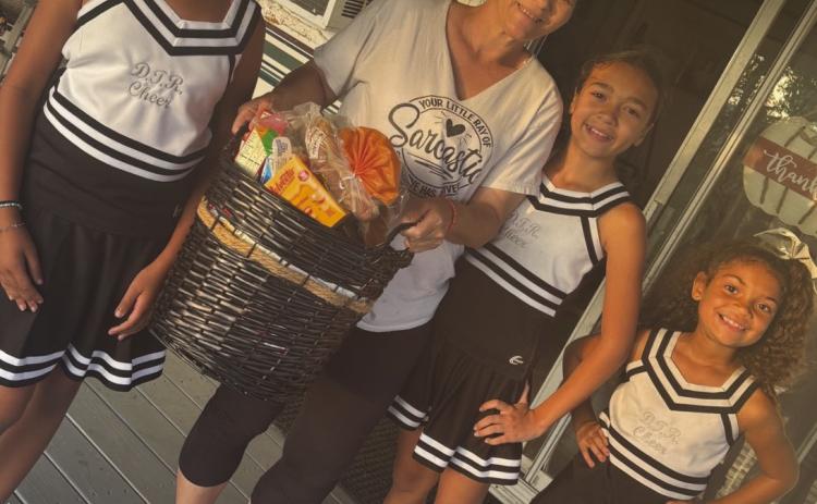 DTR Cheerleaders Provide Holiday Baskets to Parish Residents in Need