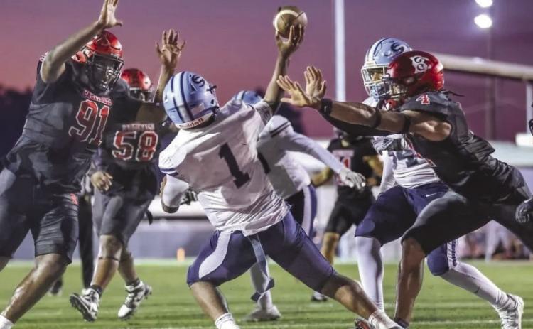 BCHS seniors Savion Barthelemy, #91, and Logan Jackson, #4, are closing in on SPHS' quarterback in the “Battle of the Boot” matchup earlier this season. Barthelemy has signed with Washington State University and Jackson with Nicholls State University for the Fall.