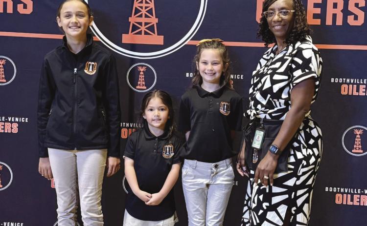 From left: Harper Guidry, Naveah Hua, Gracie Busby, and Principal Maria Prout.