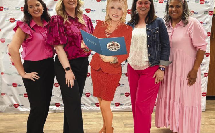 Members of the parish School Board and the Plaquemines Parish Ready start Network pose the a Dolly Parton cut-out. From left to right: Jessica Cognevich - Early Childhood Coordinator, Kaitlin Vidrine - Head Start Education Manager, Patricia Haydel - Director of Early Childhood, Megan Henry-Denet - Head Start Manager.